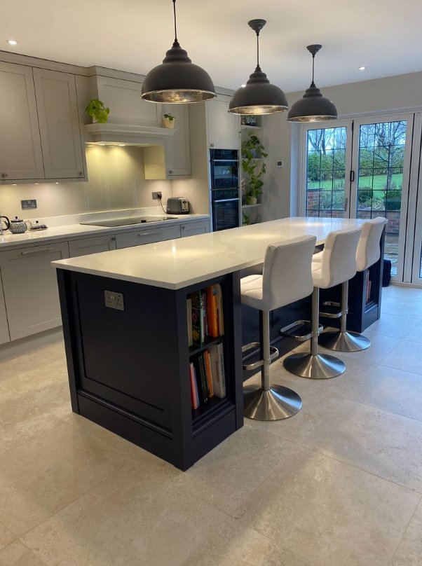 Shaker kitchen with navy island and industrial pendant lights